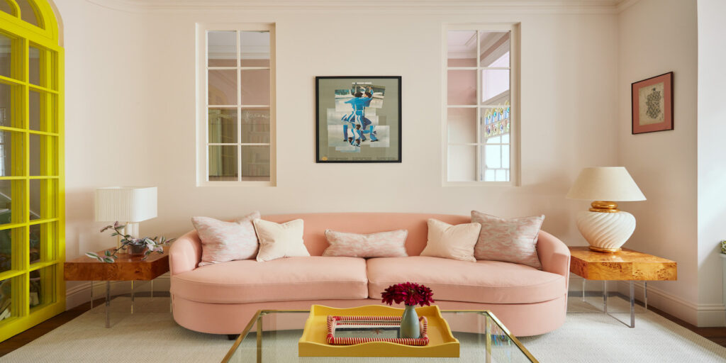 living room with large pink sofa and wall print