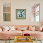 living room with large pink sofa and wall print