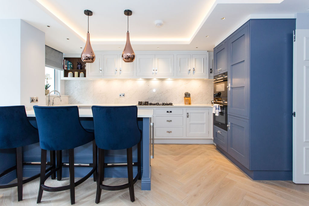 navy blue and cream kitchen with island and bar stools