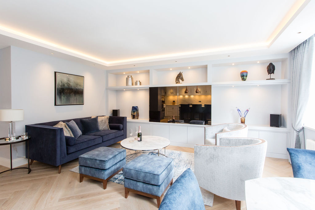 navy blue renovated living room with wooden flooring