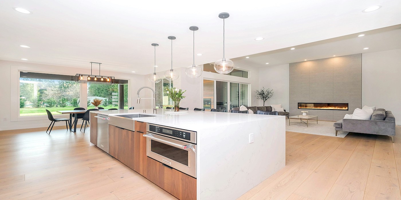 white kitchen with large island and lounge space
