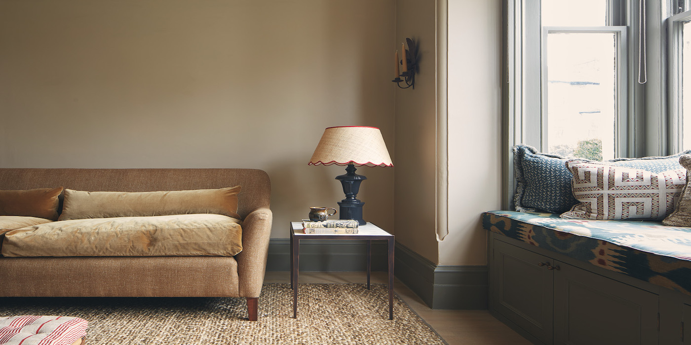 living room with beige sofa and ornate lamp